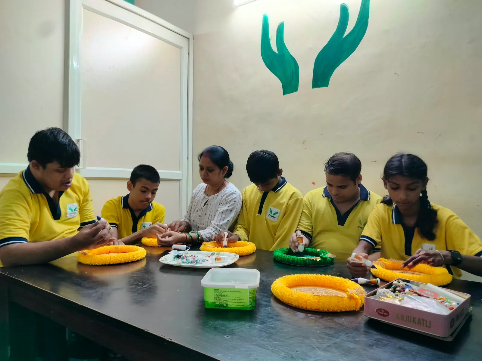 Students presenting a decorated thali they prepared together