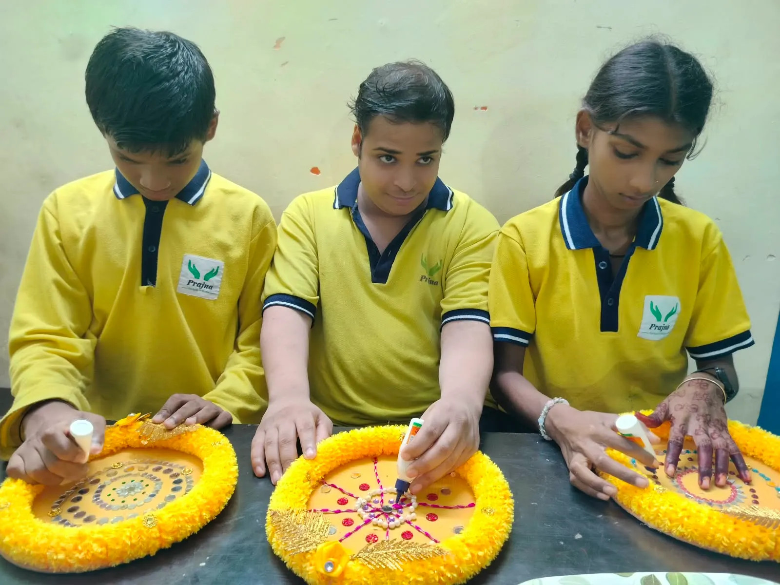 Three students concentrating on a vocational training task