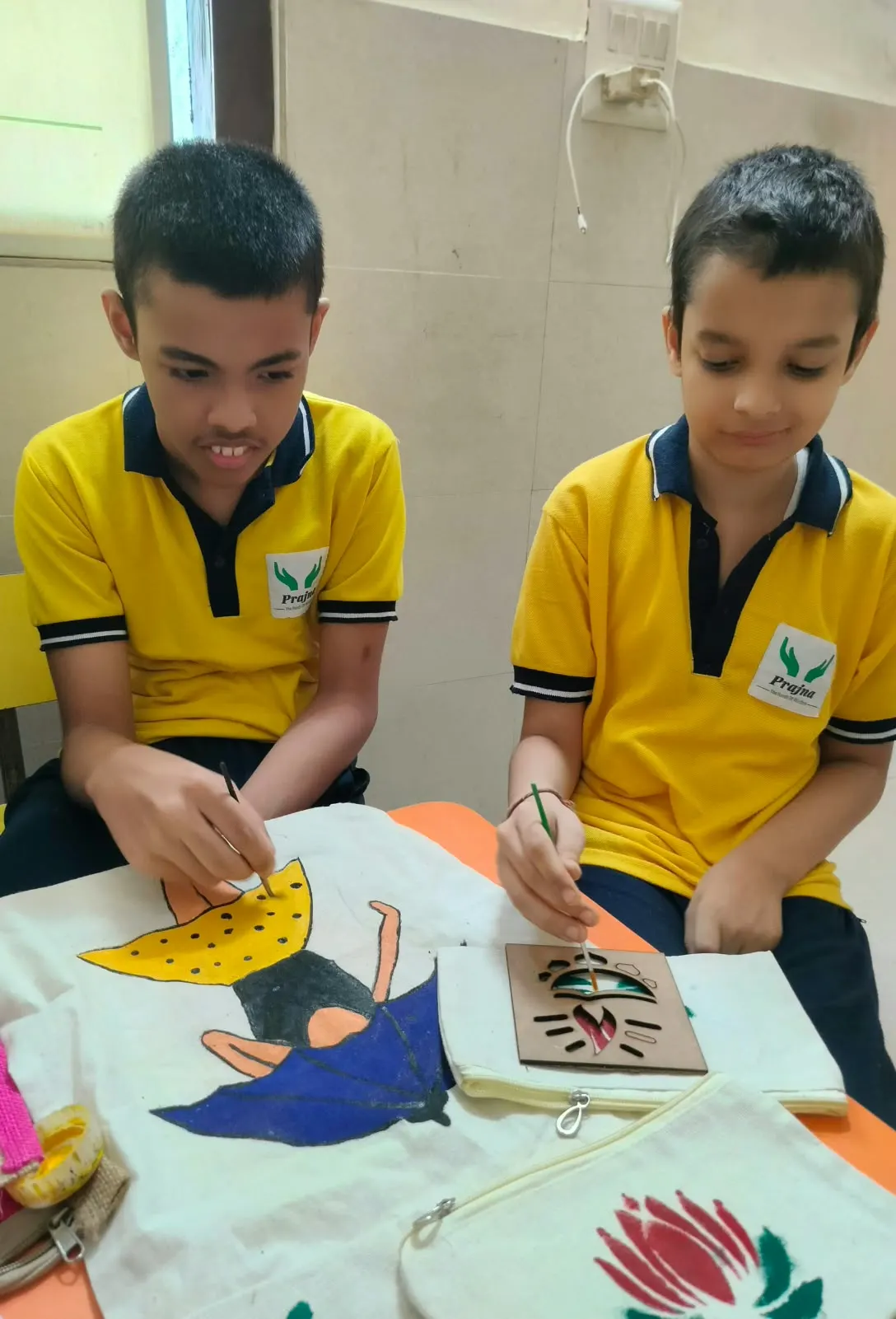 Two students with the rakhis they made